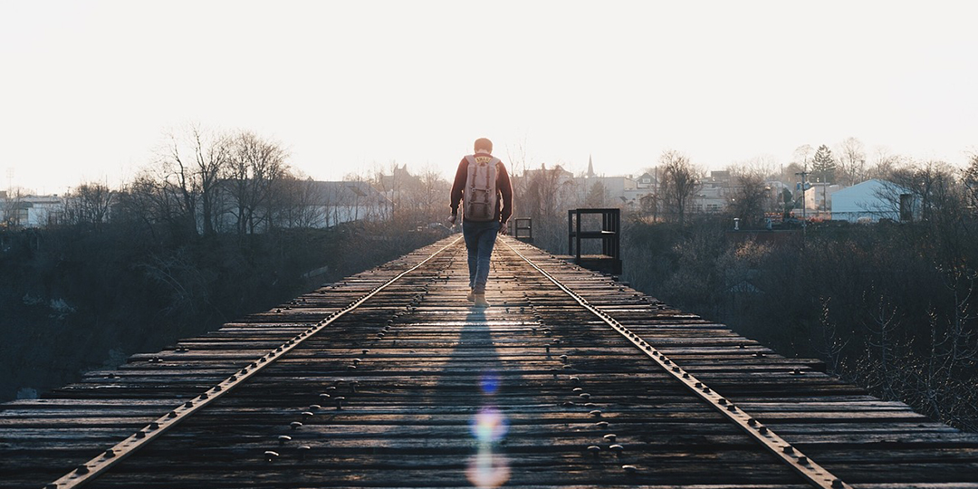 Man walking down train track